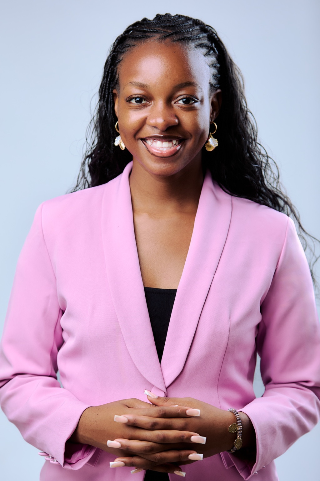 Chimwemwe Daka smiling in a blossom-pink blazer
